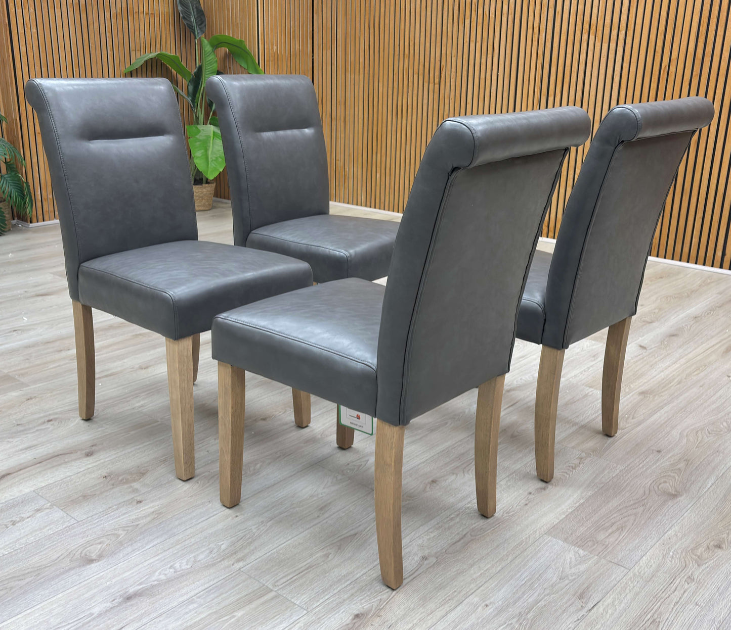 Lifestyle view of the Lewis dining chair showcasing the smooth dark grey finish and solid rubberwood construction.