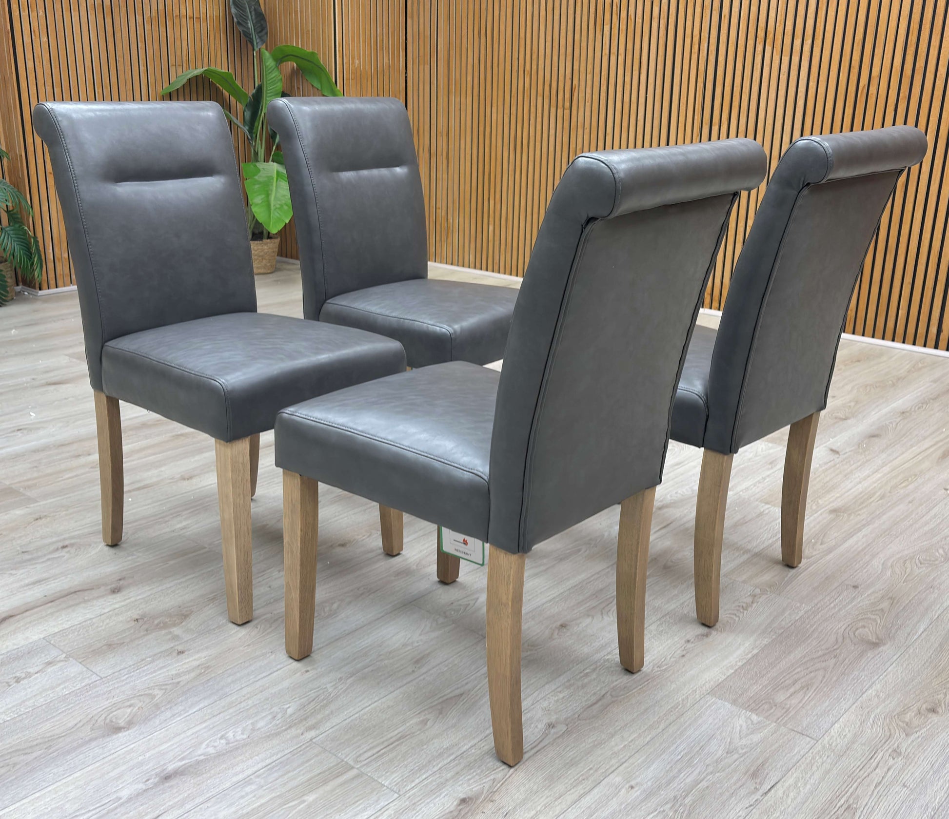 Lifestyle view of the Lewis dining chair showcasing the smooth dark grey finish and solid rubberwood construction.