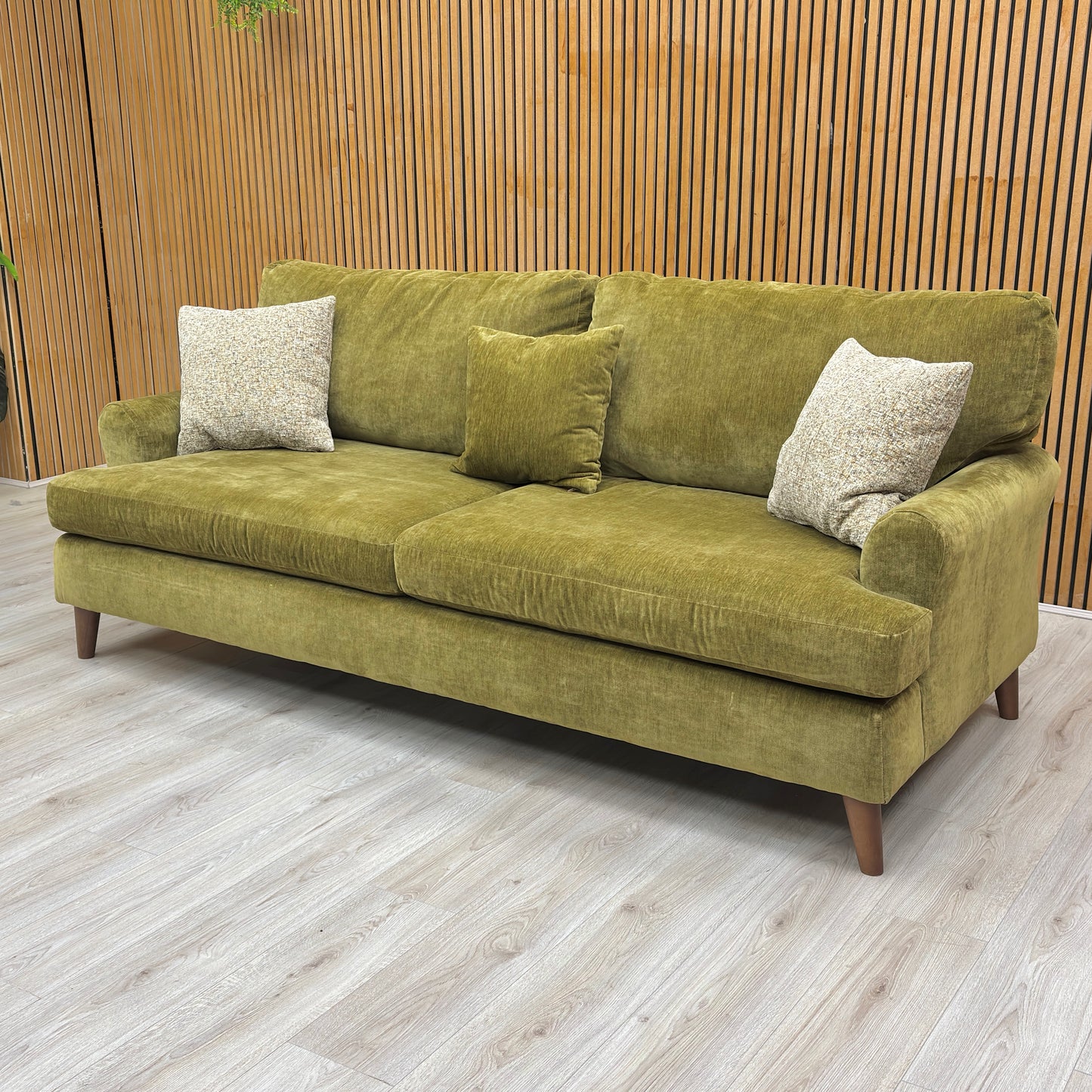 Lifestyle shot showing the rich texture of the olive green chenille weave on the Jackson sofa.