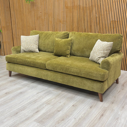 Lifestyle shot showing the rich texture of the olive green chenille weave on the Jackson sofa.