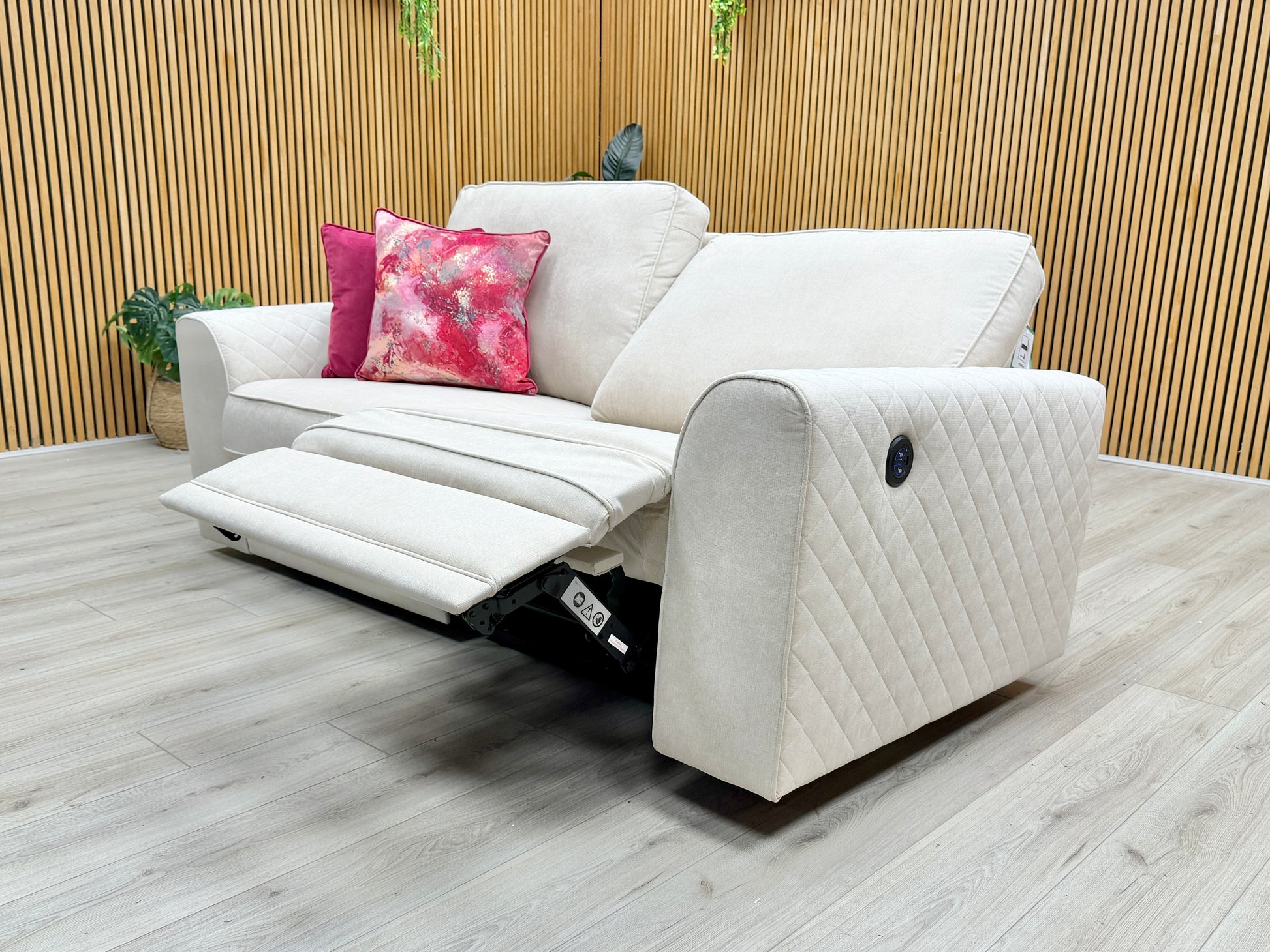 Detail view of the power reclining feature in action, showing the footrest extended for maximum relaxation.