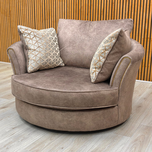 Lifestyle view of the Mariah snuggler chair, showcasing the deep-filled seat cushion and the shimmering, rich brown textured velvet finish.