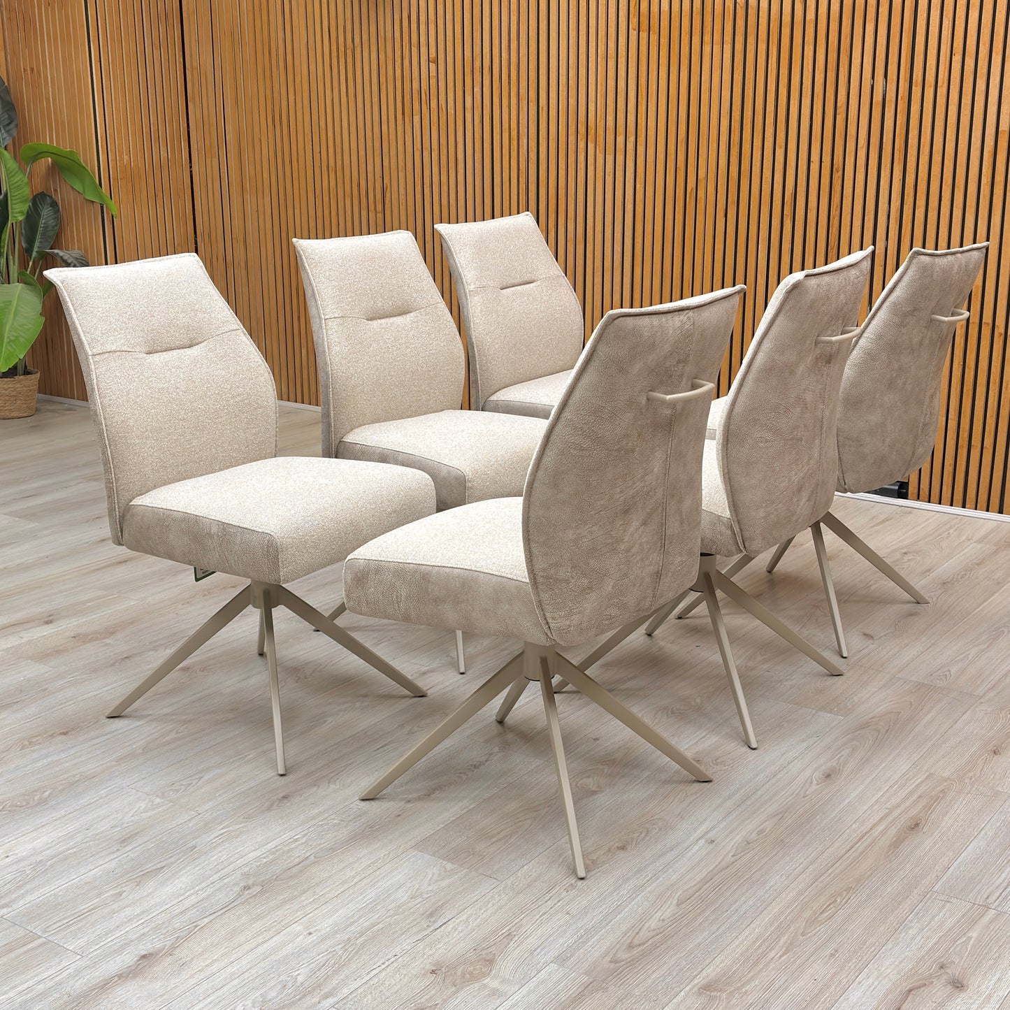 Lifestyle room view of a Mirage swivel chair, showcasing the sophisticated neutral tone and the plush, contoured padding for maximum dining comfort.