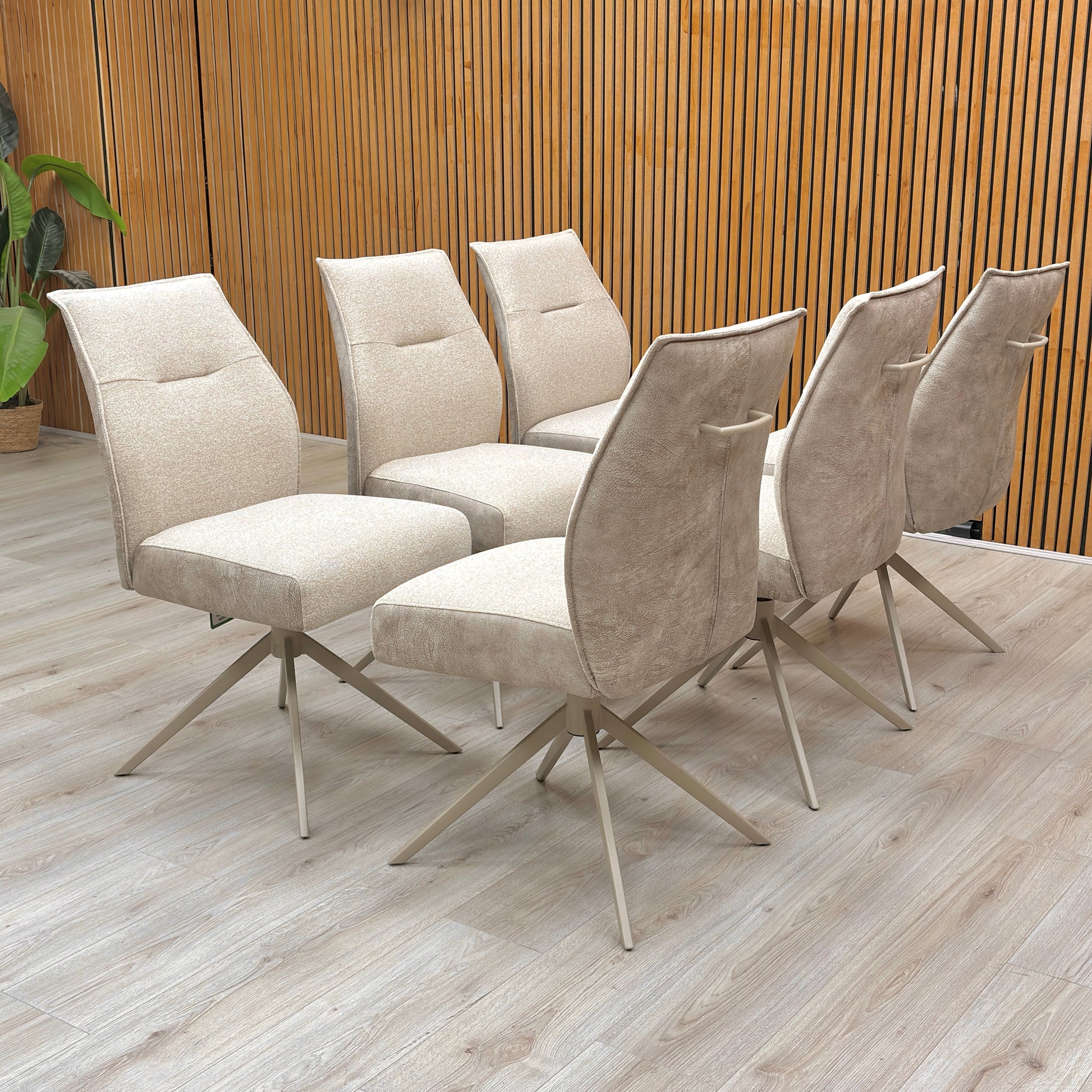 Lifestyle room view of a Mirage swivel chair, showcasing the sophisticated neutral tone and the plush, contoured padding for maximum dining comfort.