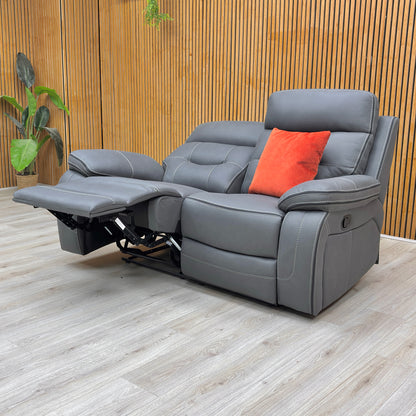 Lifestyle view of the Dante 2-seater sofa, highlighting the durable grey fabric, easy-to-use manual latch reclining mechanism, and pocket-sprung seating.