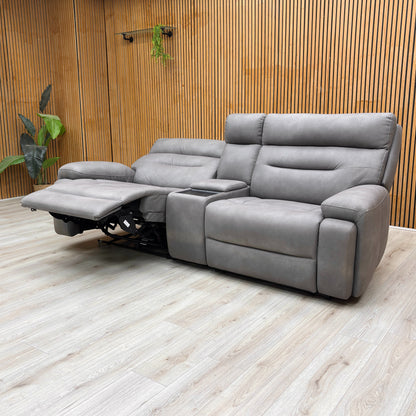 Angled view of the 'Cinemax' Media Sofa with the central backrest folded down, revealing the media tray, cupholders, and control panel.