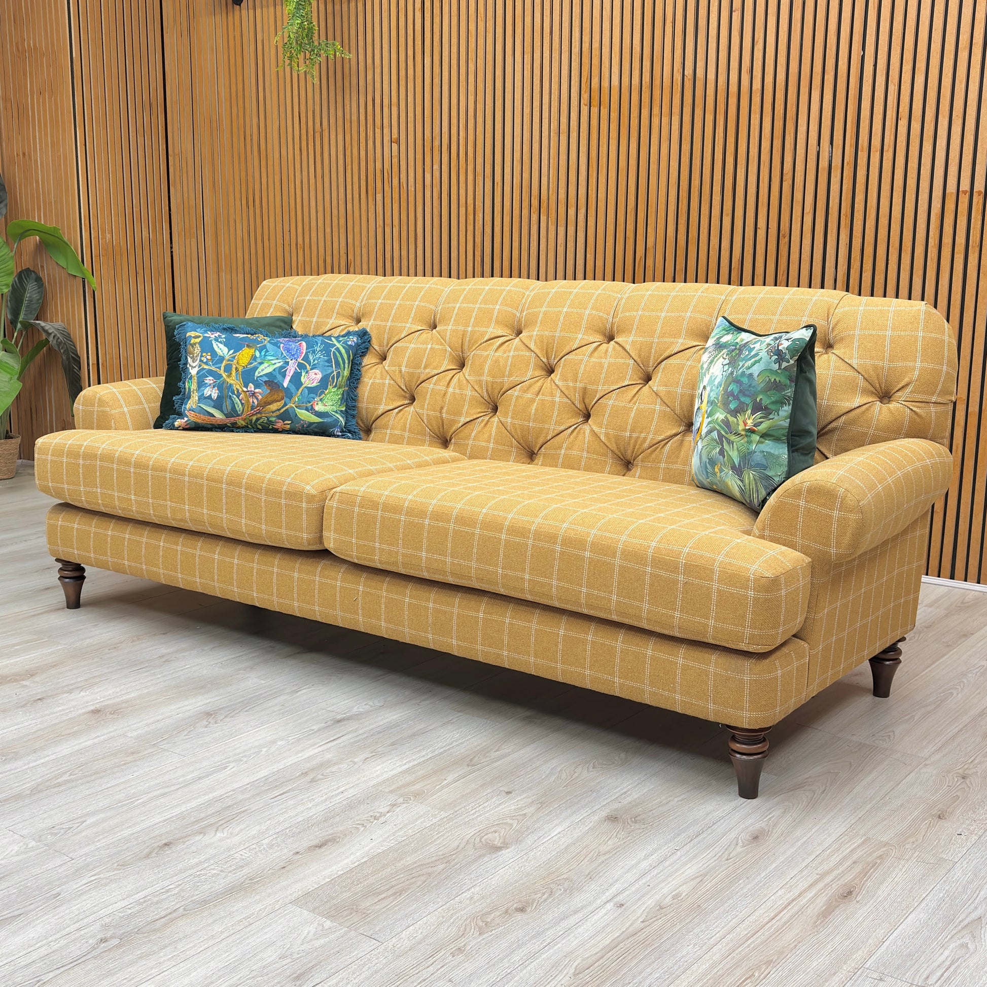 Lifestyle view of the Canterbury sofa, showcasing the warm yellow and neutral oatmeal tones and the spacious, inviting silhouette ideal for traditional living rooms.