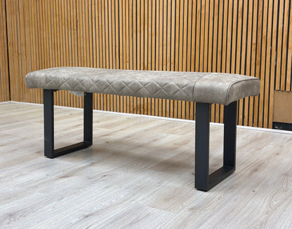 Lifestyle view of Warrior dining bench styled in a modern room setting, showcasing its versatile neutral taupe upholstery.