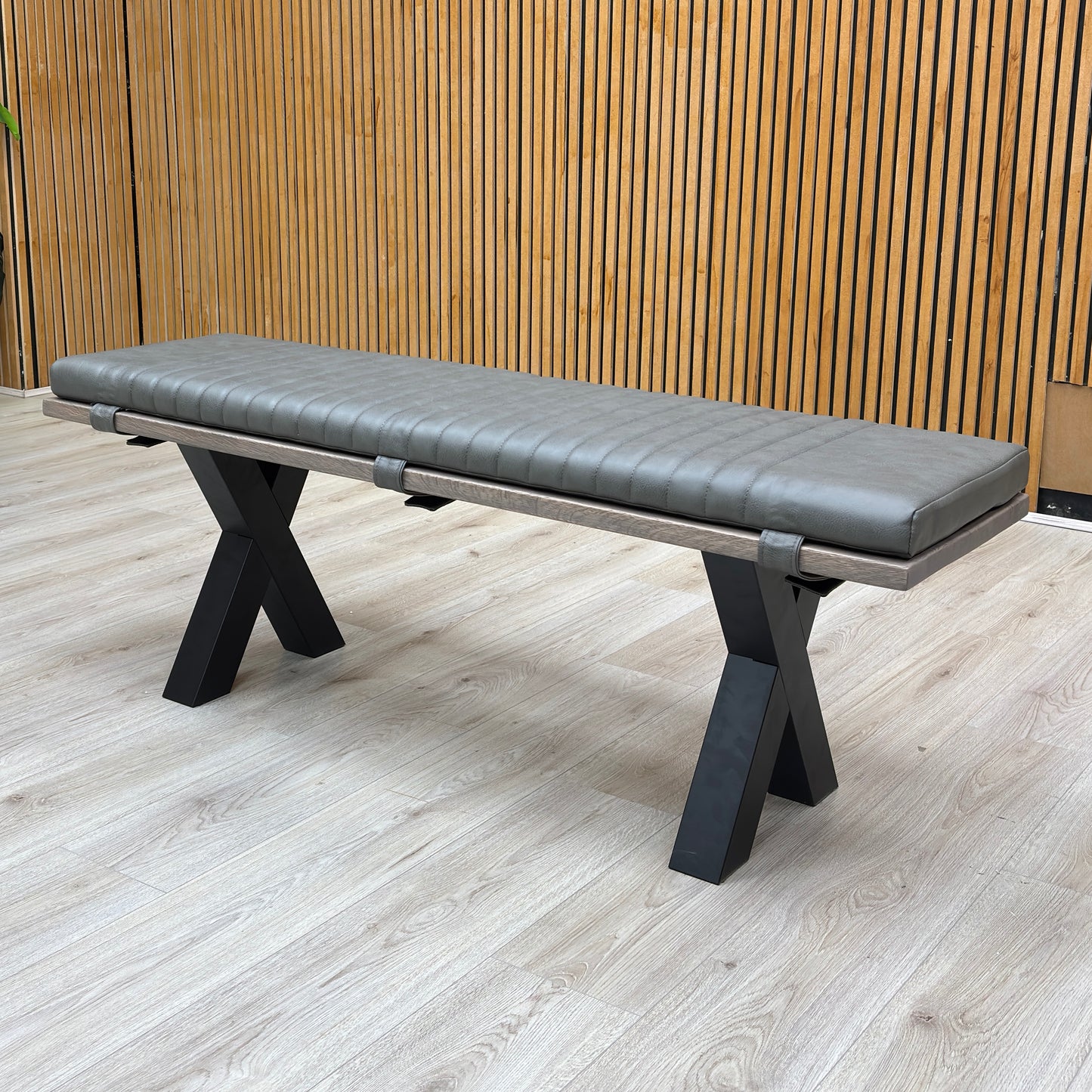 Lifestyle view of the grey padded bench cushion, highlighting the textured fabric that adds comfort to the solid oak seat.