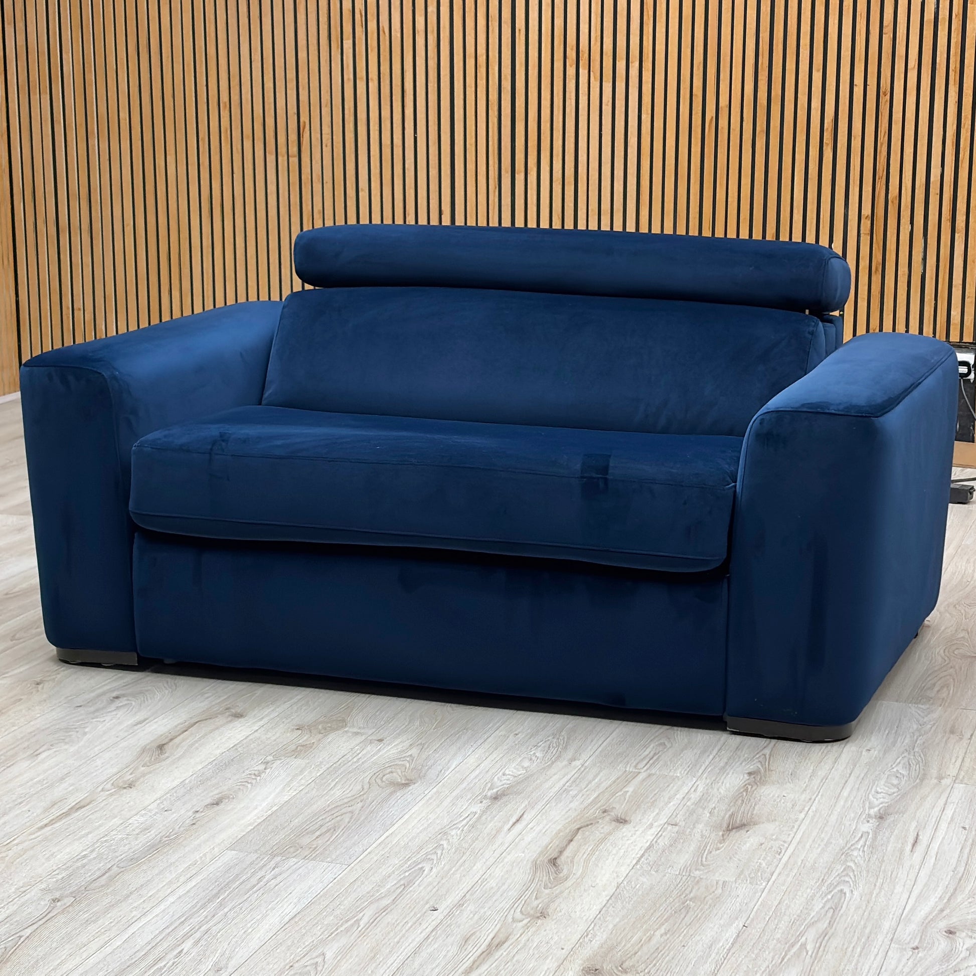 Studio view of the Infinity large armchair in its standard seating configuration, showcasing its wide layout, thick supportive cushions, and neat uniform tailoring.