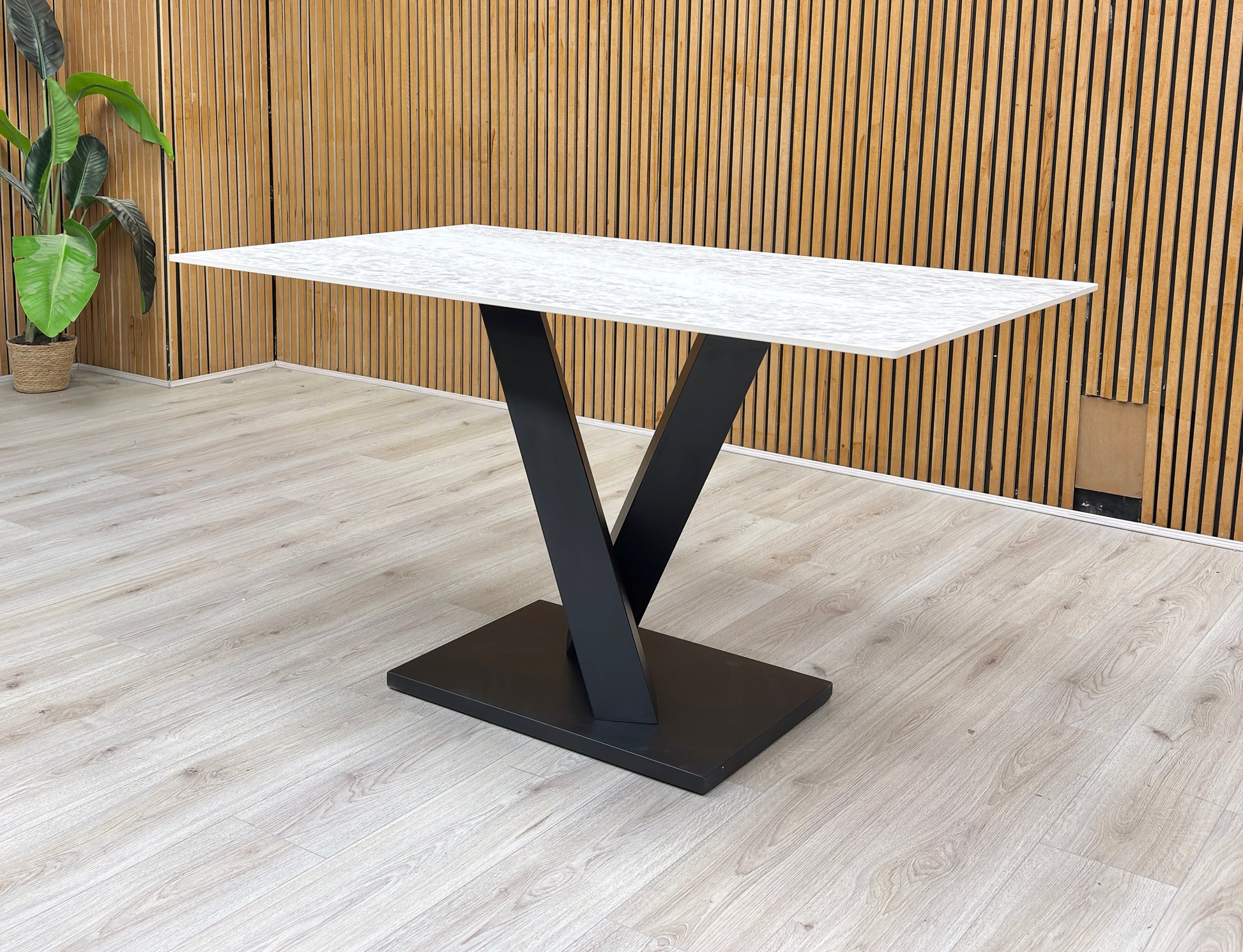 Lifestyle view of the Warrior dining table, illustrating the smooth finish and generous seating capacity for up to 6 people.