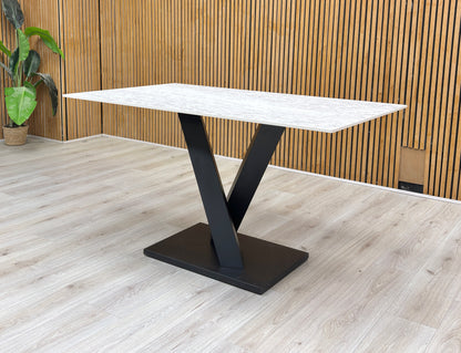 Lifestyle view of the Warrior dining table, illustrating the smooth finish and generous seating capacity for up to 6 people.