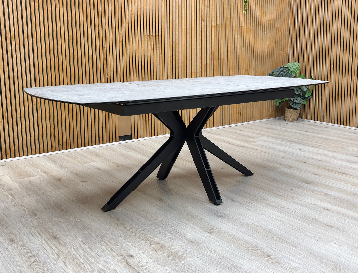 Lifestyle view of The Raul table fully extended to 210cm, illustrating the additional seating capacity for large gatherings.