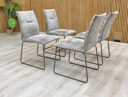 Lifestyle view of the Connubia 'Maya' dining chair set brings sophisticated Italian design and contemporary comfort to any dining space.