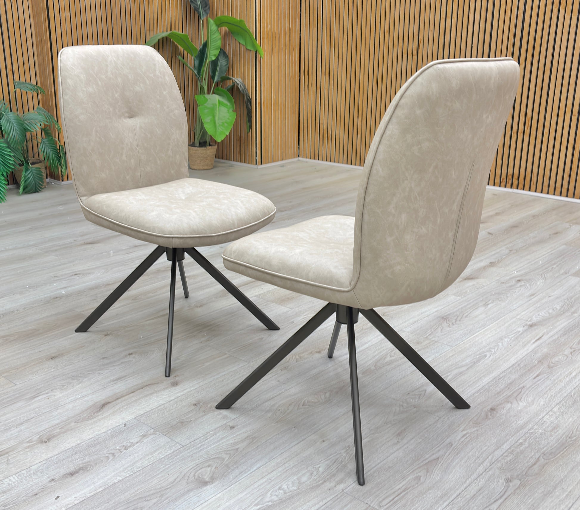 Lifestyle view of Pair of stone fabric swivel dining chairs styled in a contemporary dining room with a ceramic table.