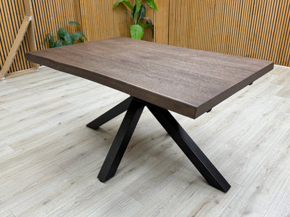 Lifestyle shot showing the 'Mars' Dark Oak Live Edge Dining Table with chairs.