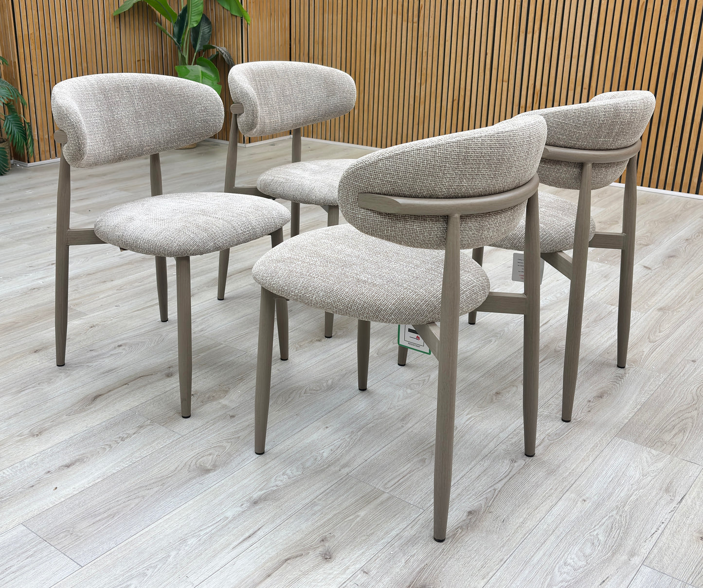 Lifestyle view of the Aimar dining chair emphasizing the elegant curve of the backrest and sturdy leg construction.