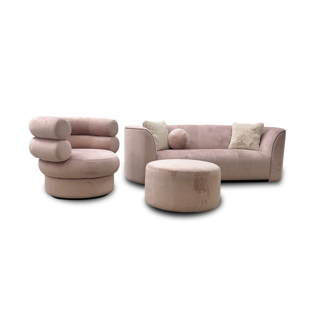 Angled view showing the accent chair and footstool next to the sofa.