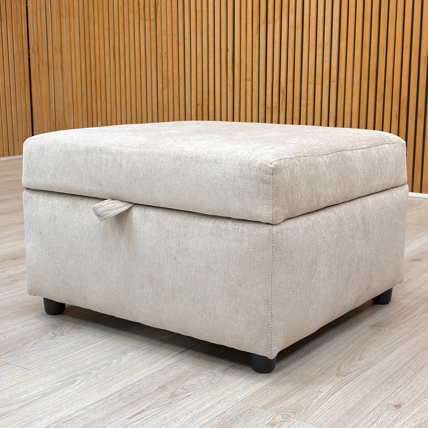 Lifestyle view of the truffle storage footstool paired with a matching sofa in a living room setting.