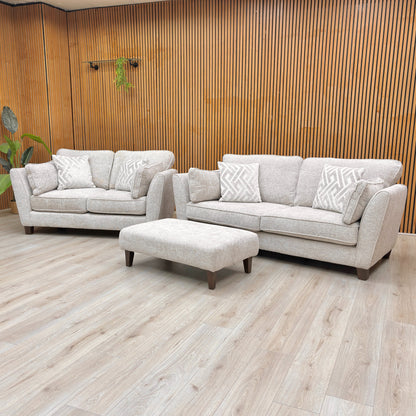 Angled view of the Tabitha 3 Seater Sofa and matching Bench Stool, emphasizing the super-soft chenille upholstery.