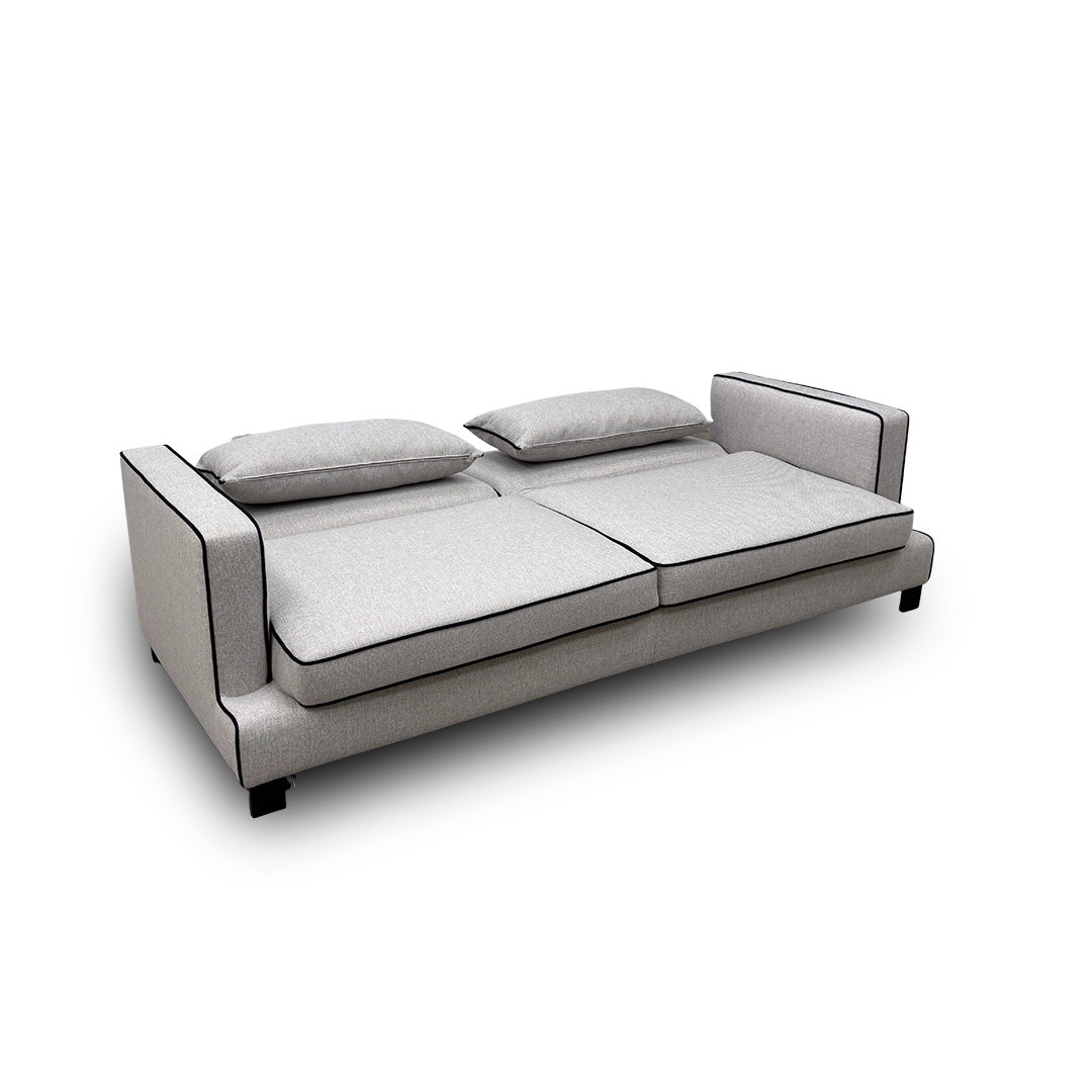 The 'Demure' Silver Sofa Bed with the hidden mattress and frame partially pulled out, showing the conversion mechanism.