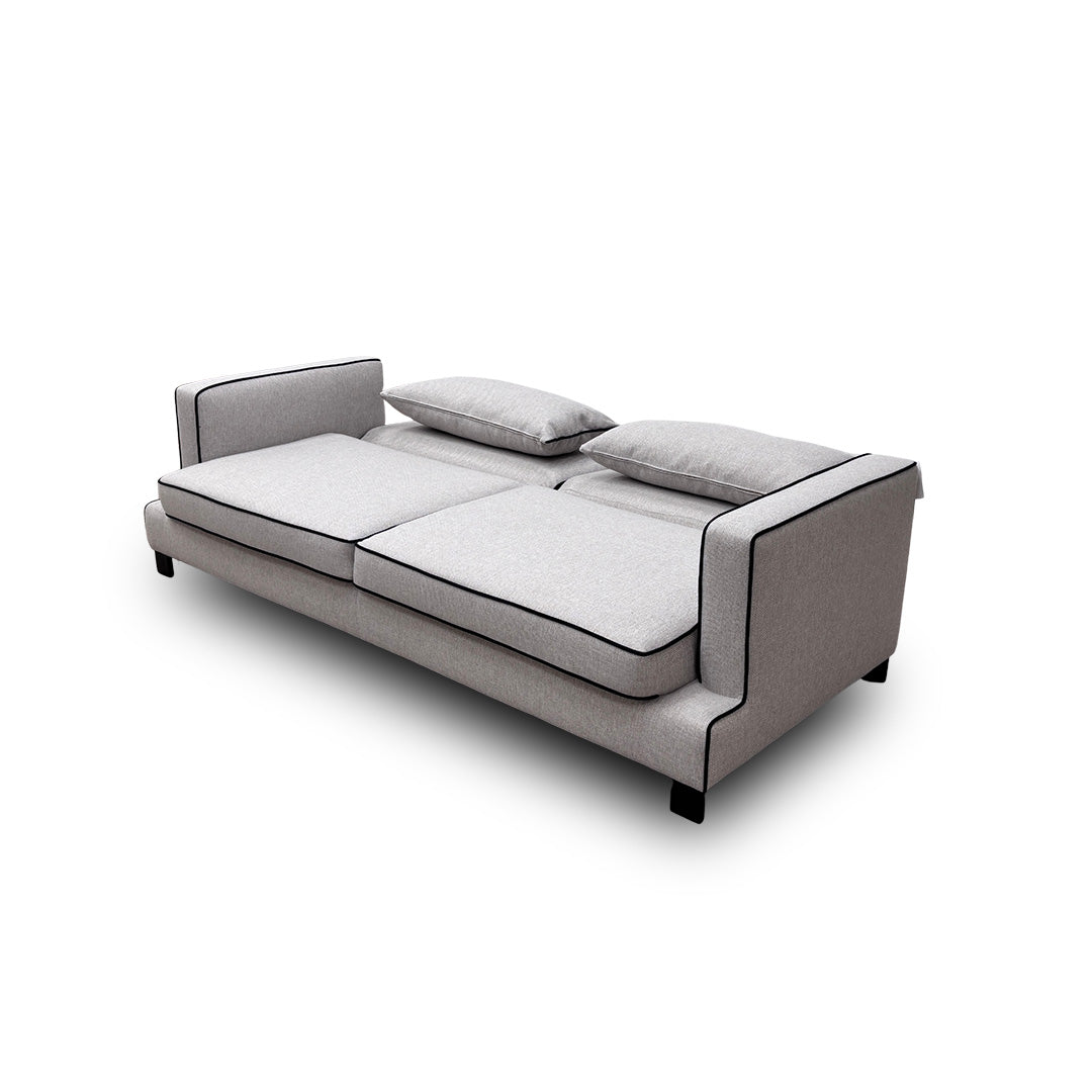 The 'Demure' Silver Sofa Bed with the hidden mattress and frame partially pulled out, showing the conversion mechanism