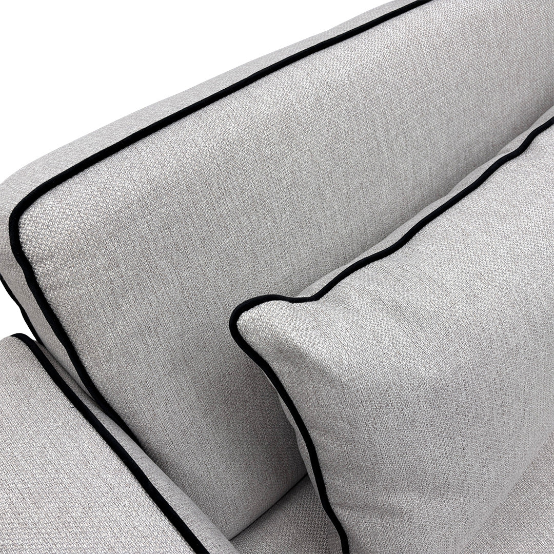 Detailed close-up of the silver upholstery, showing the textured basket-weave fabric body and the smooth velvet trim with sleek self-piping.