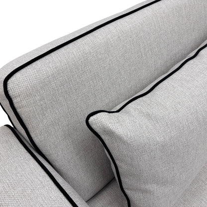 Detailed close-up of the silver upholstery, showing the textured basket-weave fabric body and the smooth velvet trim with sleek self-piping.