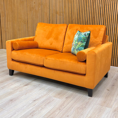 Detailed shot of the armrest area, showcasing the piping and the cylindrical bolster cushion.
