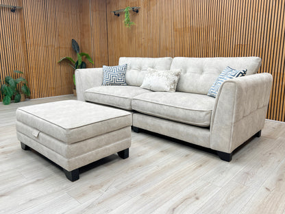 Lifestyle view of the Mariah storage footstool with the lid open, highlighting the spacious internal compartment for living room organization.