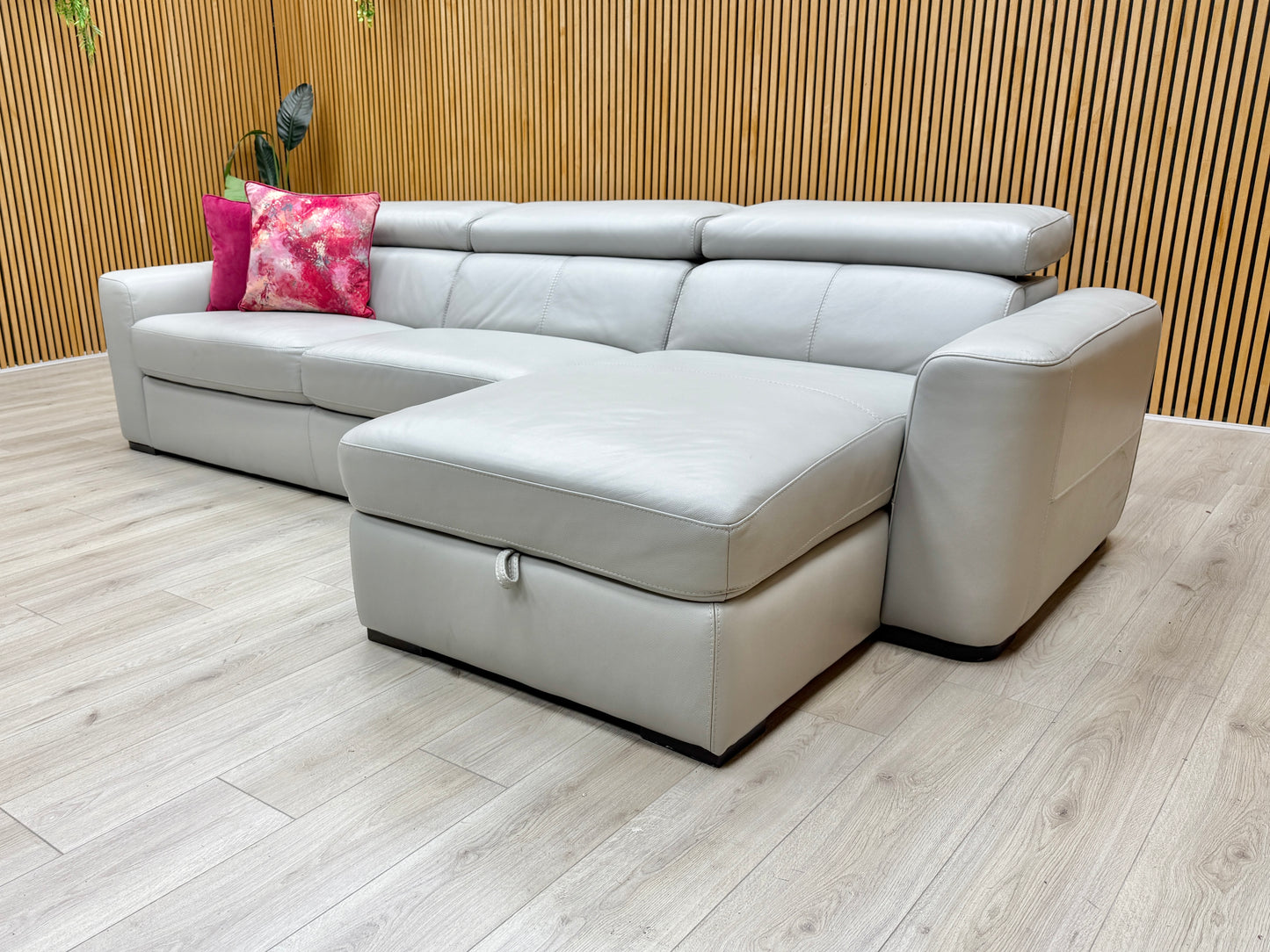 Lifestyle shot of the ‘Infinity’ grey leather corner sofa, highlighting the spacious right-hand chaise lounge.