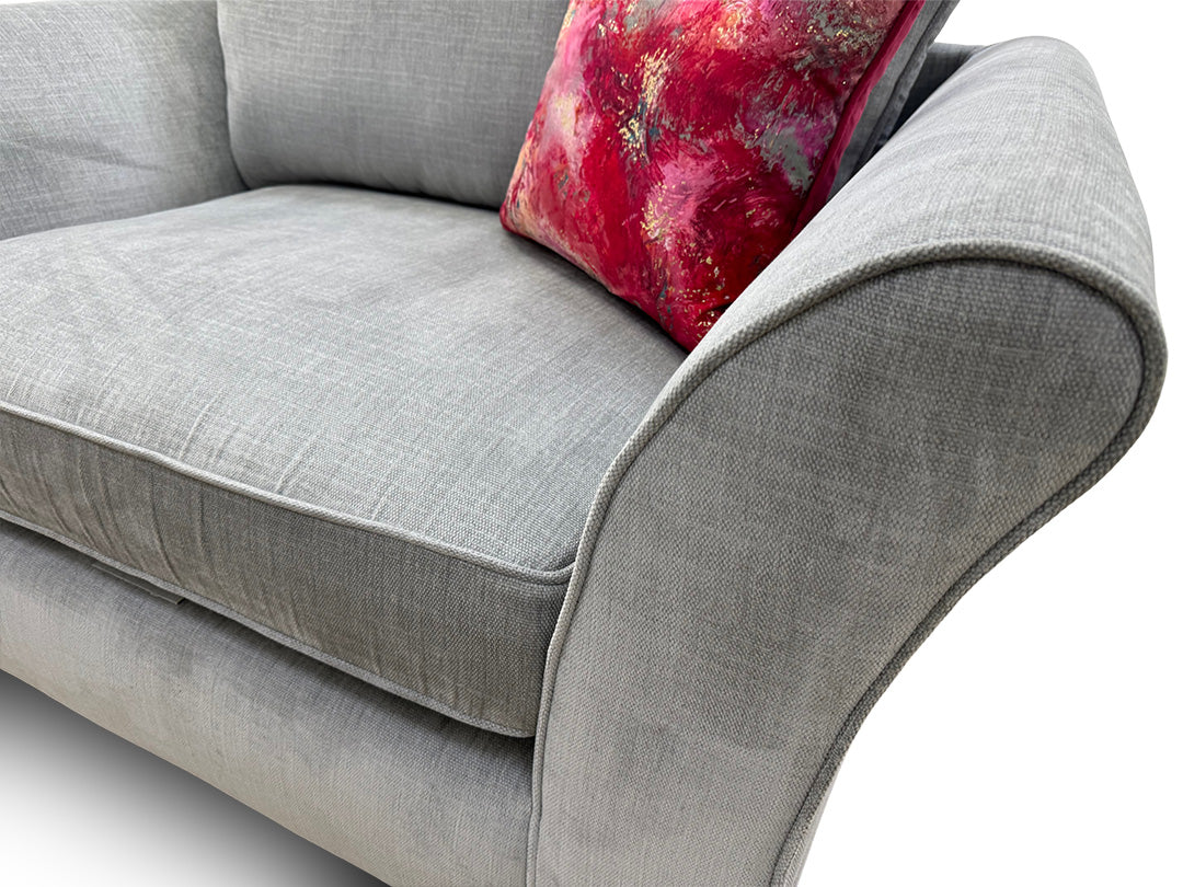 Close-up of the light grey velour fabric and deep-buttoned backrest, highlighting the premium finish, tonal depth, and high-quality upholstery work.