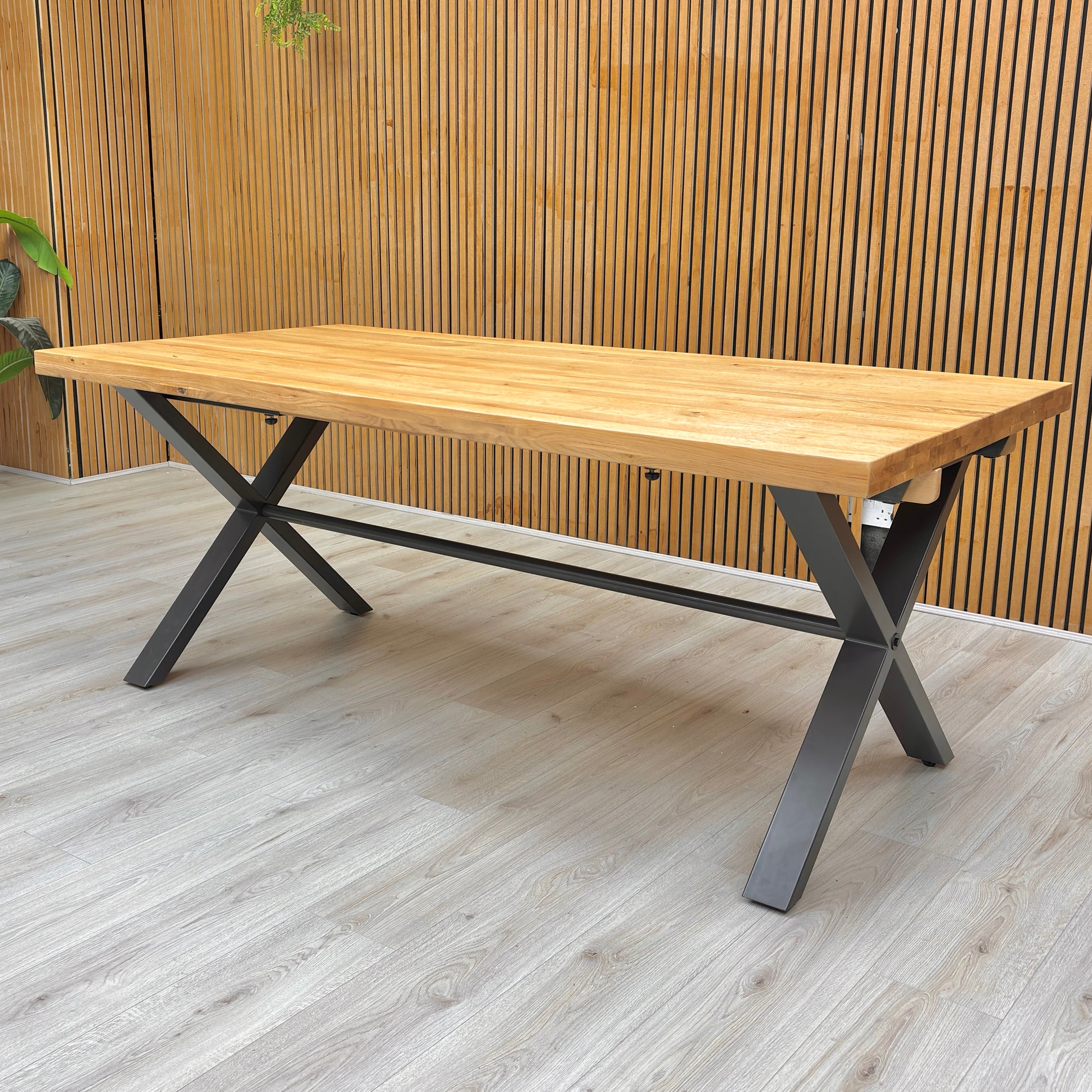 Lifestyle shot showing the large 'Earth' Fixed Dining Table set up in a dining room.