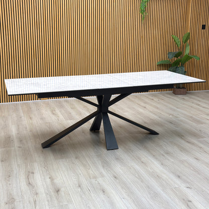 Crete ceramic top 180cm extending dining table on its own against a slatted wooden wall on a light oak floor