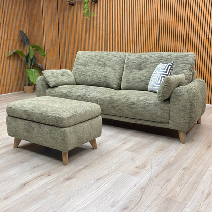 View of the sofa base and legs, highlighting minor scuffs and surface scratches on the black support feet.