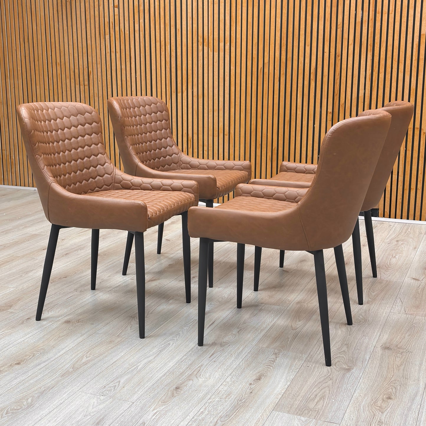 Detailed shot of the black powder-coated metal legs, illustrating the sturdy fixed base and contemporary industrial style.