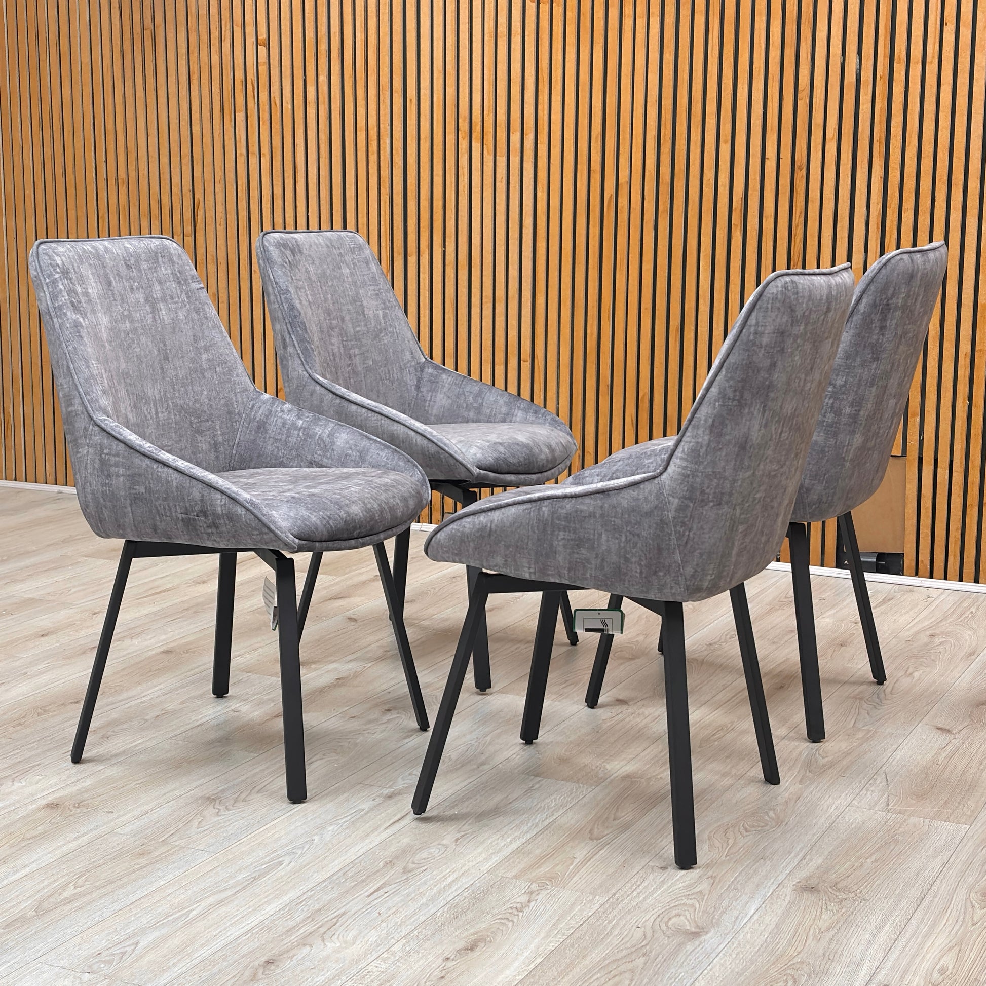 Side profile of the Veja dining chair, highlighting the 360-degree swivel mechanism and the elegant slope of the armrests.