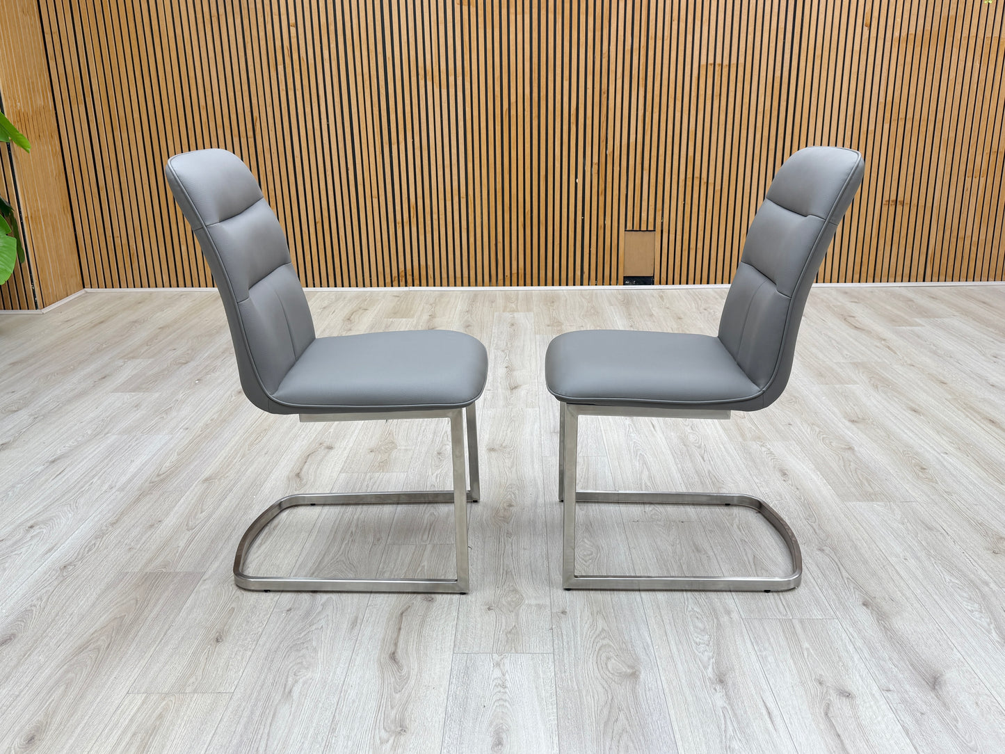 Lifestyle view of the charcoal grey faux leather upholstery and fine perimeter stitching.