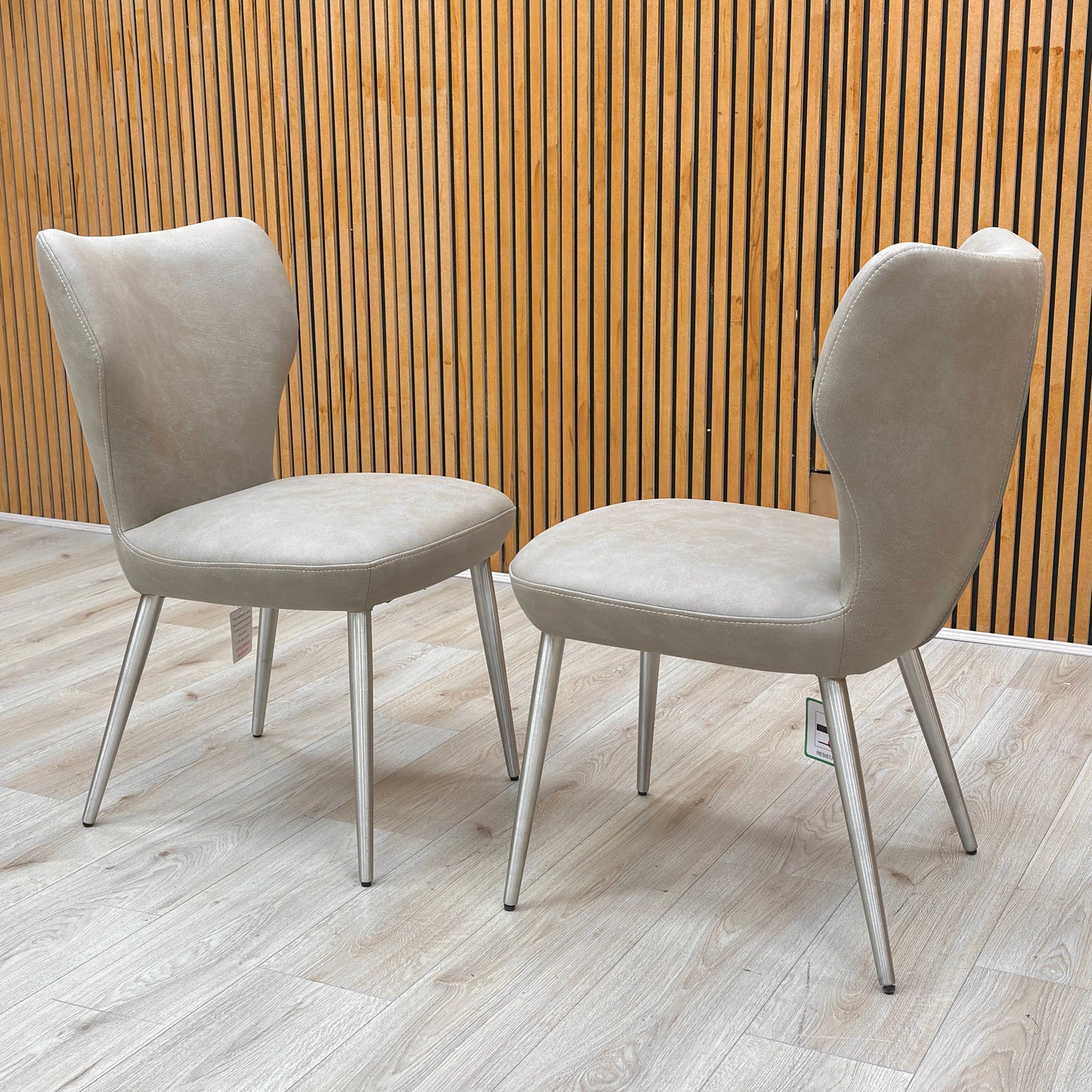 Side profile of the dining chair, illustrating the sleek metal frame and the ergonomic curve of the backrest for optimal support.