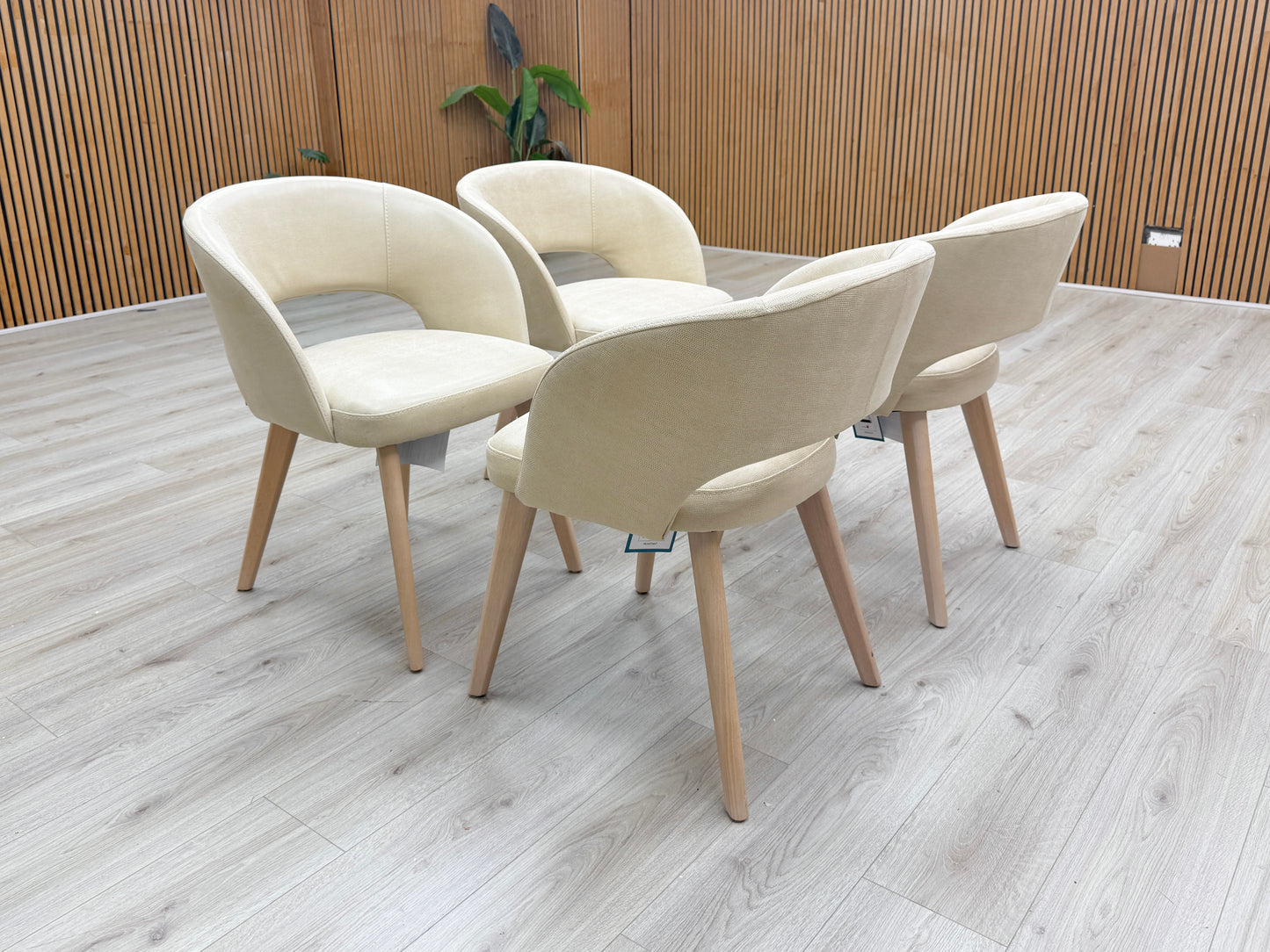 Lifestyle view of the Goya chairs showing the textured "Lizard" fabric and elegant Italian design.