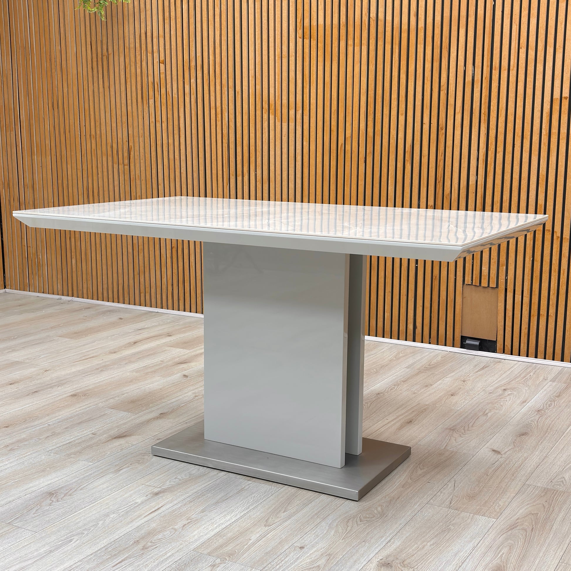 Detail of the central pedestal base sitting on a brushed stainless steel plinth for added stability and style.