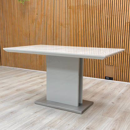 Detail of the central pedestal base sitting on a brushed stainless steel plinth for added stability and style.
