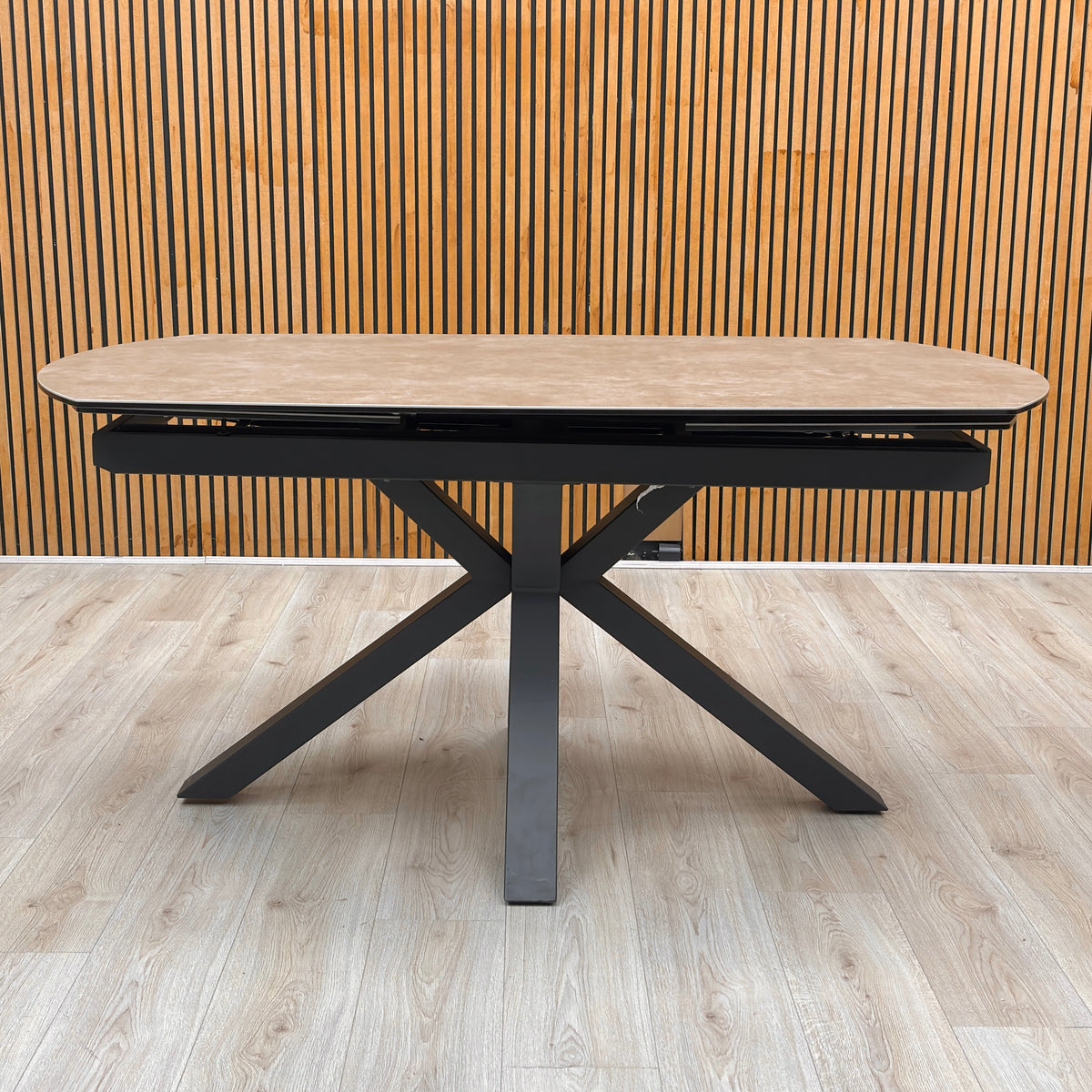 Raul argile grey ceramic 160cm dining table unextended against a slatted wooden wall on a light wood floor
