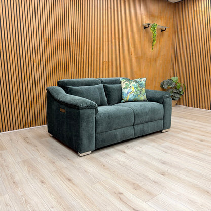 Lifestyle view of the Geneva 2-seater in Forest Green, showcasing the rich fabric texture and the sleek, supportive backrest design.