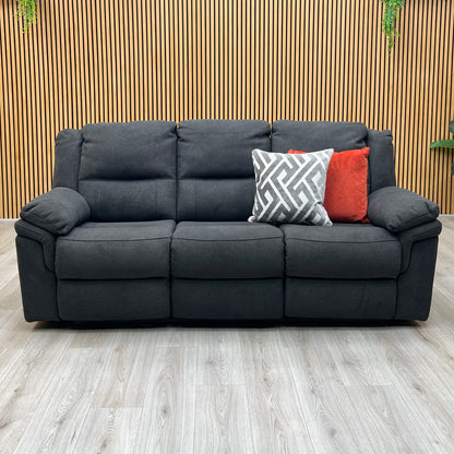 Three-quarter studio perspective with the outer seats fully extended in a relaxing recline, demonstrating the raised footrests and comfortable reclining angle.