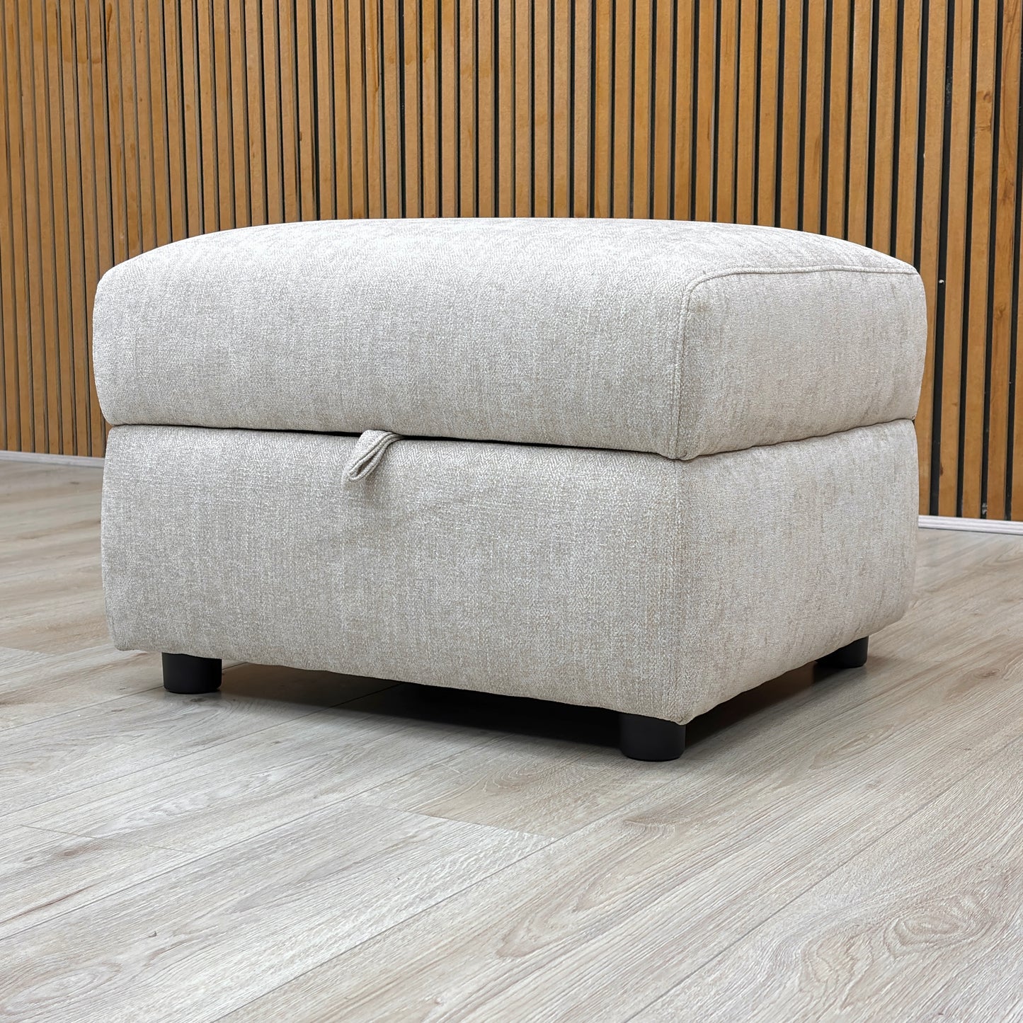 Lifestyle shot of the Hetty footstool with the lid closed, showcasing the plush padded top and contemporary minimalist aesthetic.