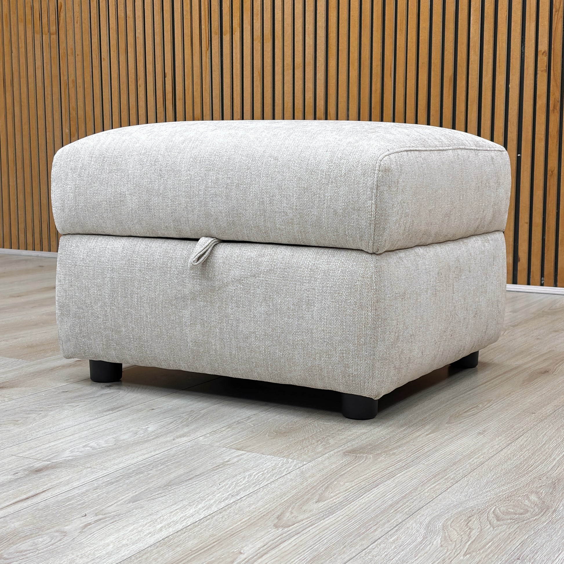 Lifestyle shot of the Hetty footstool with the lid closed, showcasing the plush padded top and contemporary minimalist aesthetic.