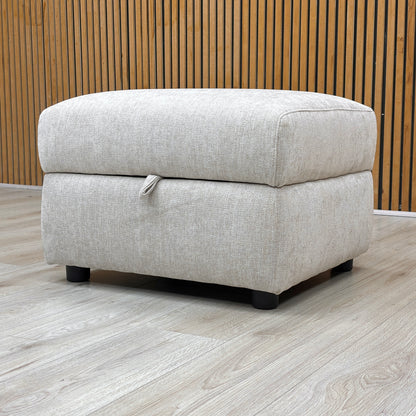 Lifestyle shot of the Hetty footstool with the lid closed, showcasing the plush padded top and contemporary minimalist aesthetic.