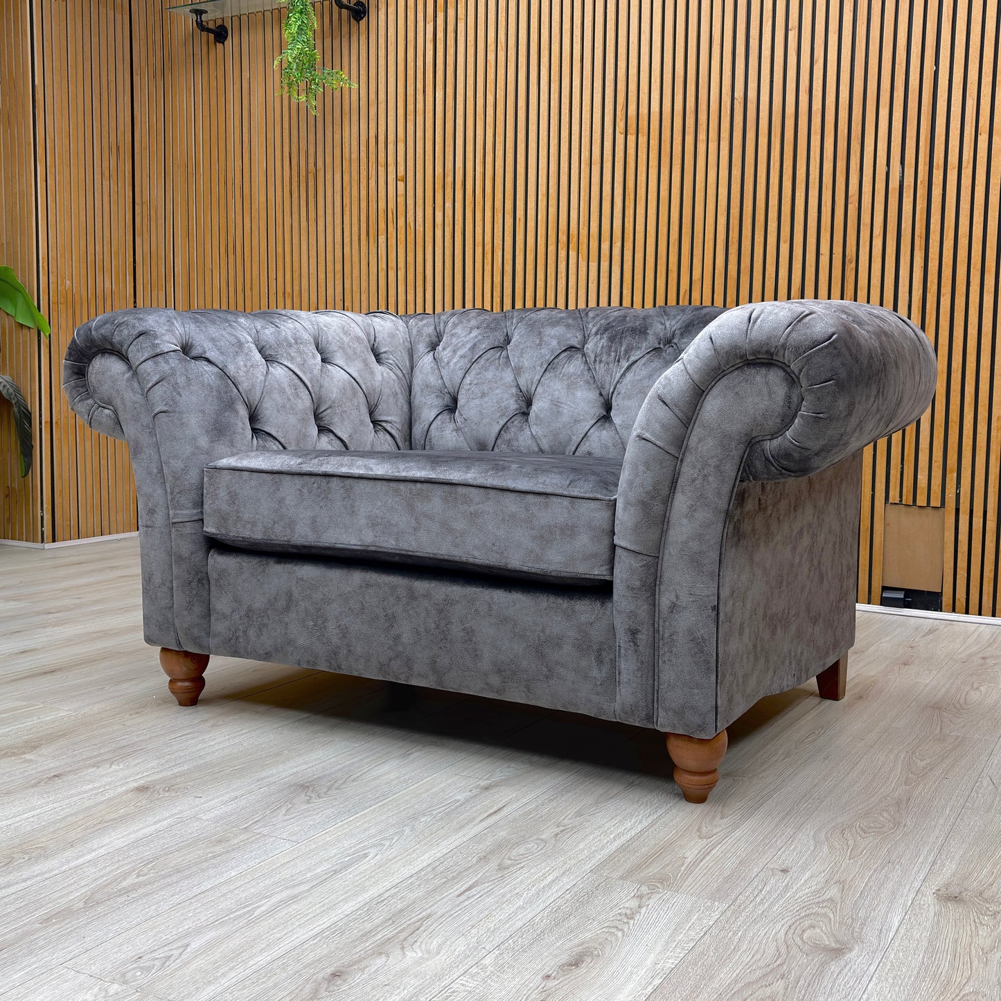Lifestyle view of the Gosford Snuggler, showcasing the oversized seat and the rich, dark grey tones of the fabric.