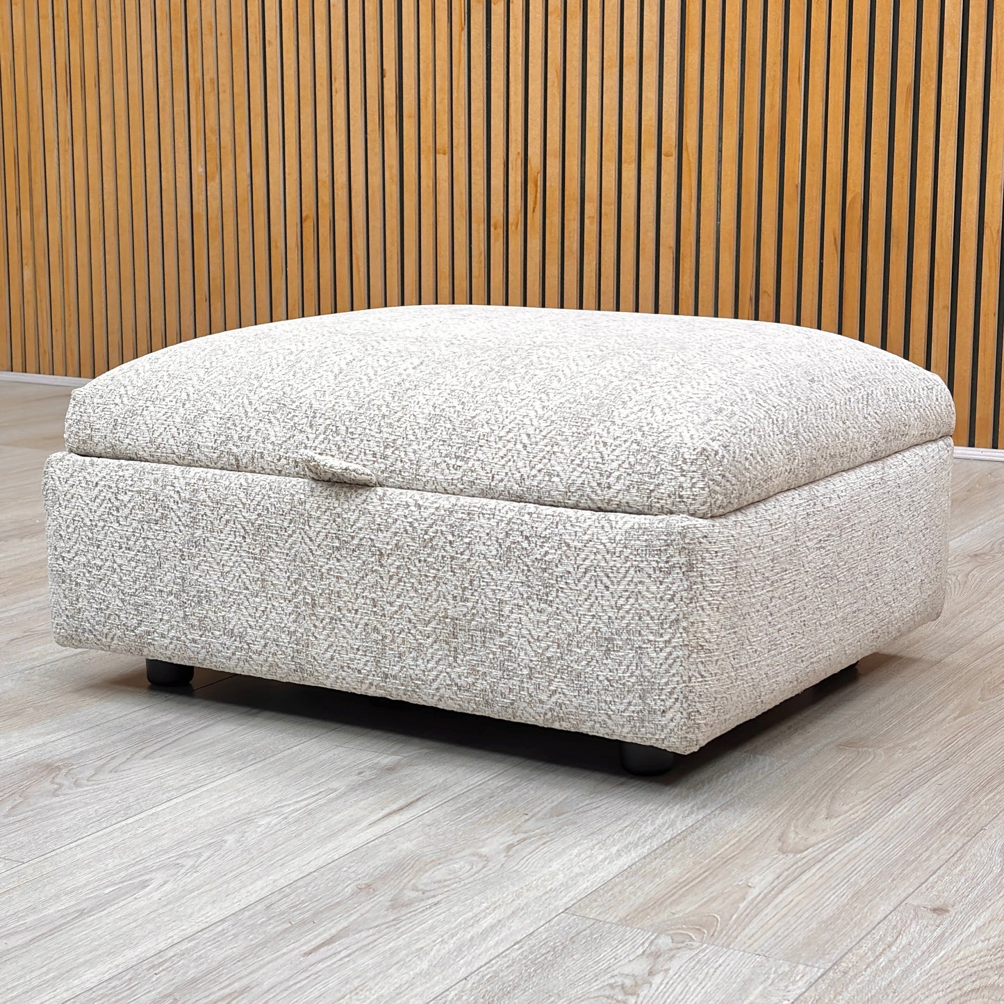 Lifestyle view of the Hudson storage stool with the lid open, revealing the spacious internal compartment designed for storing blankets, cushions, or magazines.